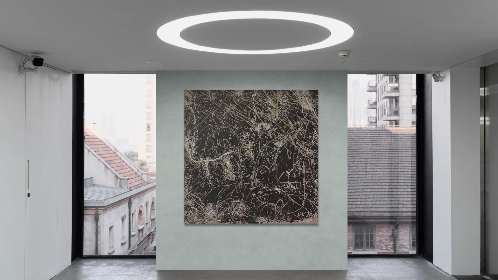 Modern room with circular ceiling light and textured wall art.