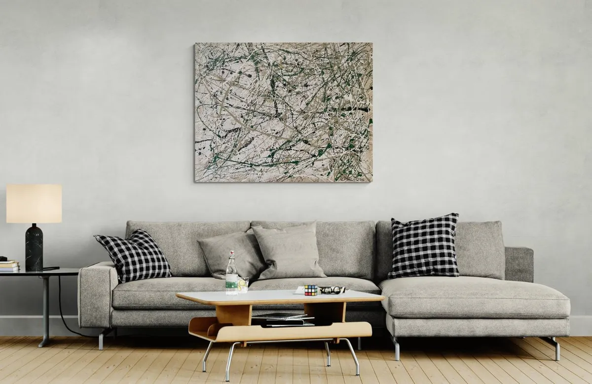 Modern living room with gray sofa and abstract wall art.